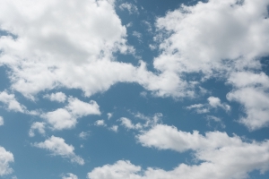 a sunny blue sky with some clouds floating by