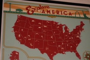 a poster by Anderson Design Group of a map of the United States with the title of ‘Explore America’ at the top and ‘From Sea to Shining Sea’ at the bottom