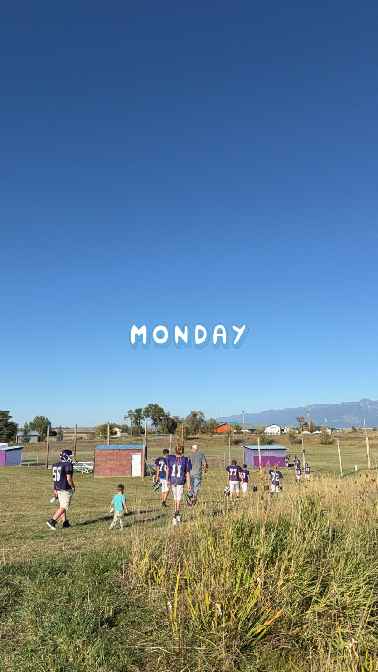 The Vikings football team and coaches walking toward the practice field on a nice Monday afternoon.