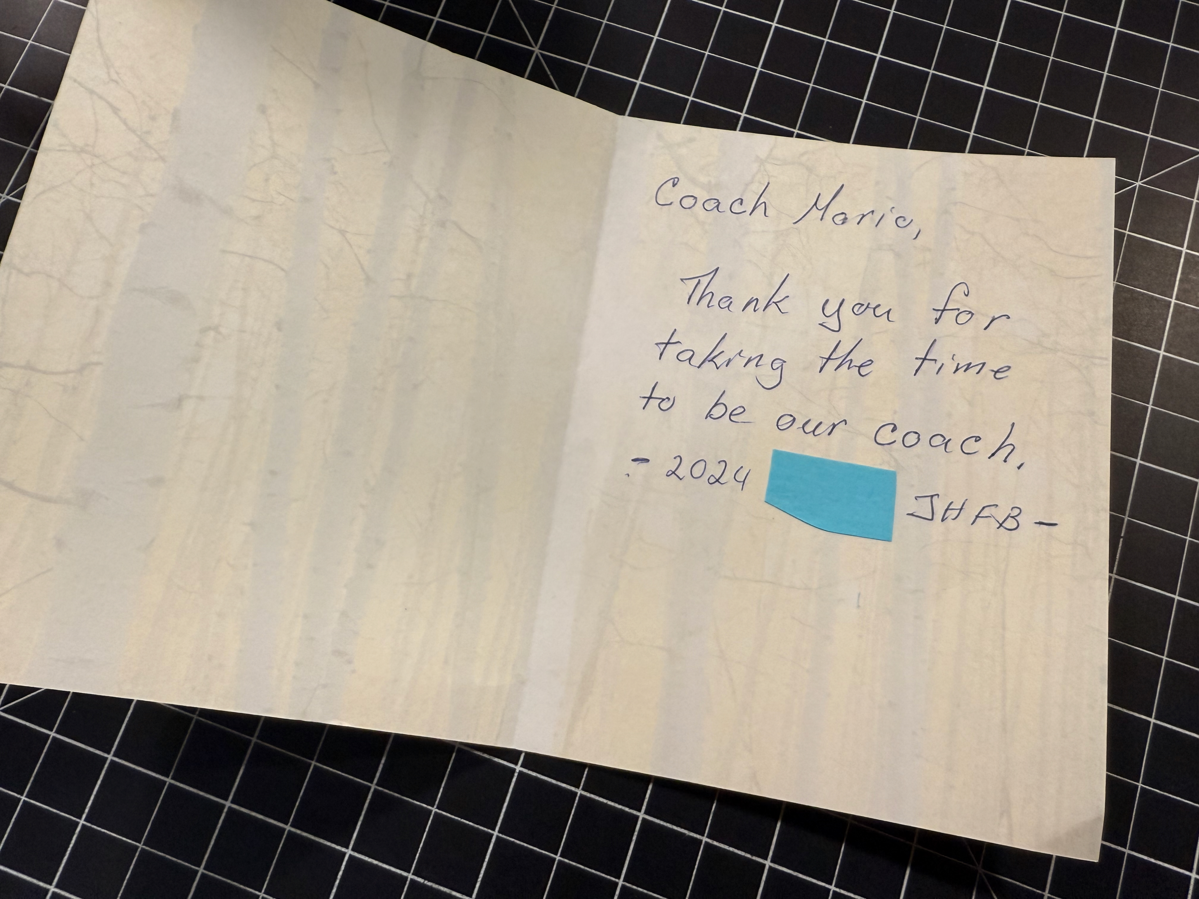 A thank you card with a handwritten note that says, Coach Mario, Thank you for taking the time to be our coach, 2024 redacted JHFB