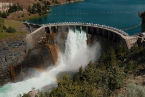 water flowing from Kerr dam and a rainbow arcing across the river