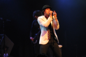 Maxïmo Park singer Paul Smith singing into a microphone at a concert